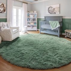 a baby's room with a green rug and white crib in the corner