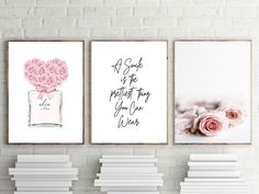 three framed art prints with pink roses and perfume bottles on the wall next to each other