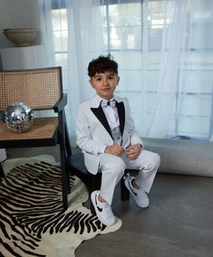 5 Piece Fashion Sequin Tuxedo Set dapper your little gentleman right up! This look is smoother than sequins with its glitter finish.  Talk about wanting to be the star of the occasion, or even just a little bling bling. Boy's 5-Piece Fashion Sequin Tuxedo Set consists of a high quality jacket, a double breasted vest, pants, shirt and bowtie.  Peak Lapel Jacket offers side vents for ventilation and comfort. Comes with matching pants. Pants need to be hemmed/tailored to match his height.  Modern Sequin Tuxedo Set is European Cut which makes it really slim, so please keep allowances in mind. Whatever the occasion, may it be a part, a wedding, or even just another day out and about- we are here for the moments for that matter! White Three-piece Suit For Party, Fitted White Three-piece Suit For Party, White Fitted Three-piece Suit For Party, White Fitted Three-piece Party Suit, White Tuxedo Three-piece Suit For Party, Tailored White Tuxedo For Party, Fitted White Set For Party, Fitted White Party Set, White Fitted Party Sets