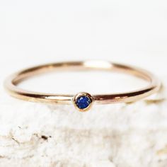 A dainty tiny birthstone ring, made with 14k gold fill! Set with a single Sapphire imitation Cubic Zirconia for your birthstone month. ∙ Gift Ready in a jewelry box! ∙ Handmade in Vancouver, Canada.  ∙ 100% 14k Gold Fill ∙ Rings Sold Individually --------------------------------- M E A S U R E M E N T :  Width: 1.25mm  Gemstone: 2mm Size: Optional (US measurement) If your ring size is not specified as an option, please message me directly so we can create a custom ring together!  --------------- Sapphire Stackable Birthstone Ring In 14k Gold, Dainty Rose Gold Sapphire Birthstone Ring, Minimalist Rose Gold Sapphire Ring Birthstone, Dainty Gold Sapphire Stackable Rings, Dainty Sapphire Ring With Bezel Setting, Dainty Stackable Sapphire Birthstone Rings, Recycled Gold Birthstone Ring For Promise, Dainty Gold Sapphire Birthstone Ring, Dainty Yellow Gold Sapphire Birthstone Ring