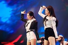 two girls in white and black outfits on stage