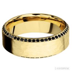 a gold wedding ring with black diamonds