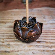 a wooden incense burner sitting on top of a wooden table