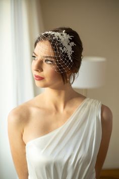 a woman in a white dress with a veil on her head