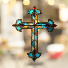 a stained glass cross hanging from the ceiling