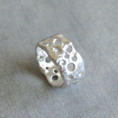 "This delicate organic shaped ring/ band is fully handmade of solid sterling silver with randomly arranged holes of different sizes. The irregular molten texture catches the light and sparkles. The model of each ring is carefully handmade of wax and cast in my home studio's foundry. The ring is elegant, not too chunky on the finger and very comfortable to wear. It is a sturdy, lasting piece of jewelry.  This gorgeous ring ring is ideal for everyday wear and it will also look amazing with a festi Wax Silver Jewelry, Silver Ring Chunky, Art Clay Silver Ring, Organic Silver Jewellery, Sterling Silver Jewelry With Unique Texture, Silver Sterling Jewelry With Unique Texture, Silver Clay Ring Ideas, Silver Ring Handmade, Chunky Silver Ring