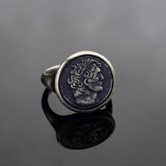 Embrace the legacy of ancient history with our Sterling Silver Alexander The Great Coin Ring, a stunning piece of jewelry that combines timeless design with historical significance. This 925 Sterling Silver ring features an Archaic Engraved Face of Alexander The Great, making it a perfect accessory for those who admire mythology and classical art. Handcrafted with precision, this Greek Coin Ring is a tribute to the ancient world, capturing the power and authority of historical figures like Julius Caesar. The intricate detailing and bold design give this Silver Signet Ring an air of sophistication and strength, ideal for lovers of historical and mythology-inspired jewelry. This Alexander The Great Coin Ring makes an unforgettable gift for any occasion, especially for those who appreciate hi Timeless Ring, Greek Coins, Julius Caesar, Silver Signet Ring, Jewelry Workshop, Coin Ring, Alexander The Great, Christmas Charms, Handcrafted Rings