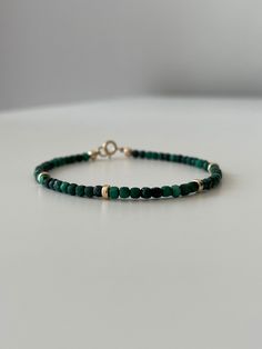 Enhance your style and benefit from the healing properties of malachite with this stunning bracelet. Crafted with exquisite malachite stones and gold-filled accents, this bracelet effortlessly combines beauty and positive energy. Whether you're looking to make a fashion statement or harness the healing powers of malachite, this bracelet is the perfect accessory for any occasion.  Malachite is believed to promote personal growth and transformation. It aids in releasing negative emotions, such as Gold Malachite Bracelet, Green Malachite Beaded Bracelets, Gold Malachite Jewelry Hand-strung, Handmade Green Malachite Bracelets, Green Malachite Spiritual Beaded Bracelets, Hand-strung Gold Malachite Jewelry, Spiritual Green Malachite Beaded Bracelets, Elegant Handmade Malachite Bracelets, Green Malachite Bracelets With Natural Stones