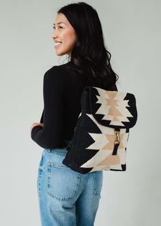 Black, cream and tan Aztec inspired backpack Clasp closure on the front Adjustable straps and handle Measures 14" x 11.5" x 4.5" 100% Cotton Lining: 100% Polyester Blouses Vintage, Flannel Sweatshirt, Top Graphic Tees, Long Jumpsuits, Vintage Sweatshirt, Headband Hairstyles, Sweater Skirt, Vintage Tees, Black Cream