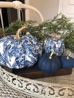 three blue and white pumpkins sitting on a tray