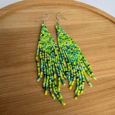 Add a playful touch to your summer style with our Summer Vibes Fringe Earrings! These zesty lime green earrings feature a fun beaded fringe, perfect for adding a pop of color to any outfit. Get ready to rock some serious summer vibes! Trendy Summer Tassel Dangle Earrings, Trendy Dangle Tassel Earrings For Summer, Bohemian Green Tassel Earrings For Beach, Summer Yellow Dangling Beads Earrings, Green Fun Beaded Earrings For Gift, Yellow Summer Earrings With Dangling Beads, Fun Green Beaded Earrings For Gift, Summer Yellow Earrings With Dangling Beads, Yellow Dangling Beads Earrings For Summer