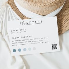 the hat is next to a business card on top of a white sheet with blue and gray circles