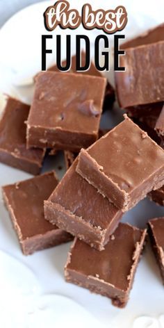 chocolate fudge on a white plate with the words best fudge in front of it