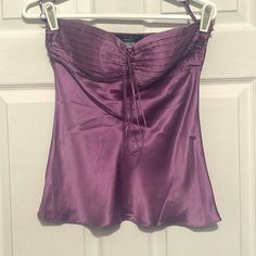 a purple top hanging on a white door