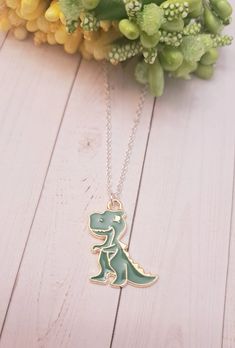 This cool dinosaur Charm Necklace is the perfect gift for someone special!  The charm is made of high-quality gold. This makes an excellent gift for yourself or your friends and family members who loves to collect Dinosaur jewelry. Product Details: Material: Sterling silver plated necklace Chain Length: 18 Inches (Can be made in different lengths) Charms: Dinosaur Charm. Please reach out to me  You can get these personalized necklaces in any length, so please contact me via Etsy Conversations if you need any size. This minimalist and dainty necklace is made with a high-quality material that is eco-friendly, durable, and anti-inflammatory. It won't leave your skin green due to marks. Moreover, the weight of the necklace is quite appropriate, and they come with a Lobster Clasp to provide you Novelty Jewelry With Lobster Clasp For Gift, Themed Necklace With Lobster Clasp As Gift, Personalized Green Jewelry For Best Friend Gift, Novelty Charm Necklaces For Gifts, Nickel-free Novelty Charm Necklace For Gift, Gold Novelty Charm Necklaces For Gifts, Gold Novelty Charm Necklace For Gifts, Novelty Necklace With Lobster Clasp For Gift, Cute Green Necklace For Gifts