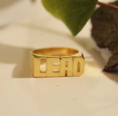 Modern Block letter name ring in 14k solid gold is a perfect statement ring for you or gift for your loved one, Best friend and so many other gift possibilities. Yes Modern block letter ring is Unisex. Sample of words: SEPARATE HANDS OR ONE FINGER 1.LOVE YOU. 2.PEACE LOVE 3.MEN NAME 3.YOUR NAME and many more....( contact me for more info) *COLOR* White gold 14k. Yellow gold 14k. Pink gold 14k. *SIZES* NAME 3/4'' to 1 '' depends on the name it is going to be adjusted accordingly by the ring size. Gold Initial Ring With Custom Name For Promise, Gold Ring With Custom Text, Gold Rings With Custom Text For Anniversary, Custom Text Gold Rings For Anniversary, Custom Text Gold Ring, Gold Promise Ring With Custom Text, Name Rings Personalized, One Best Friend, Gold Initial Ring