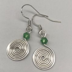 Bead: 4mm Swirl: 7/8 Of An Inch French Hook Earwires Comes In An Organza Drawstring Bag Silver Wire Wrapped Round Bead Earrings, Silver Wire Wrapped Earrings With Round Beads, Spiral Beaded Silver Jewelry, Silver Spiral Beaded Jewelry, Silver Swirl Wire Wrapped Earrings, Swirl Earrings, Earrings Green, Accent Colors, Drawstring Bag