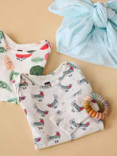 Add some fun to nursery essentials with Tea's soft long sleeve body suit two-pack set. You and your little one will love our new, buttery soft fabric. Fitted with some stretch to keep baby comfy. Easy-to-dress features like an envelope neckline and snap closure make diaper change a breeze.

Vegetable garden and cool chicken prints are hand drawn by our artists in San Francisco. Both prints can be worn solo or easily layered with one of our coordinated outfit sets. Printed Long Sleeve Cotton Onesie, Playful Long Sleeve Onesie For Summer, Playful Long Sleeve Summer Onesie, Long Sleeve Onesie For Bedtime In Spring, Playful Long Sleeve Printed Onesie, Printed Long Sleeve Onesie For Bedtime, Spring Long Sleeve Onesie For Loungewear, Spring Long Sleeve Loungewear Onesie, Organic Cotton Long Sleeve Onesie For Spring