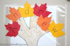 an autumn tree made out of paper with the words abc and w cut out on it