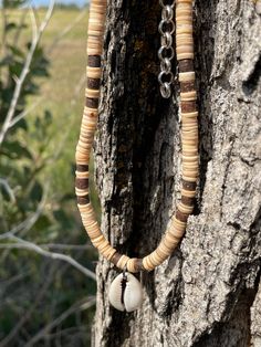 "Choker is made from thinly sliced shell heishi beads and coconut heishi beads. It has a cowrie shell for a pendant. Length is 16\" and has a chain adjustment. Item 329" Brown Shell Necklace For Vacation, Handmade Brown Shell Necklace For Vacation, Handmade Bohemian Heishi Beads Shell Necklace, Bohemian Handmade Shell Necklace With Heishi Beads, Handmade Bohemian Shell Necklace With Heishi Beads, King Of Fighters, Cowrie Shell, Heishi Beads, Mens Accessories Fashion