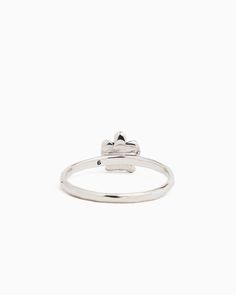 a white gold ring with a heart on the top and a small diamond in the middle