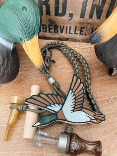 an image of a bird on a chain with other items in front of it that is laying on the table