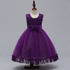 the dress is purple and has a bow at the waist