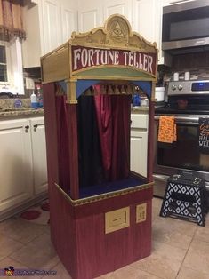 a fortune teller in the middle of a kitchen with red curtains on it's sides