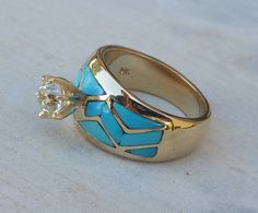 *Made to order:  Genuine, natural Sleeping Beauty turquoise inlay accents a beautiful Old European cut diamond. Fashioned of 14k yellow gold and set with a 1 Carat Old European cut diamond, grade: SI1 (color H-I), Sizes: 4-7 Completion time is 2-3 weeks from the time order is placed.  All of our made-to-order pieces have a wide variety of customization options including metals, stones and stone sizes and colors.  Handcrafted by Reyes Alfonso Ulibarri To see our full selection please visit www.Sp Luxury Turquoise Diamond Ring As Gift, Yellow Gold Inlay Jewelry For Anniversary, Fine Jewelry Turquoise Ring In Yellow Gold For Anniversary, Yellow Gold Turquoise Ring For Anniversary, Fine Jewelry Yellow Gold Turquoise Ring For Anniversary, Luxury Gold Turquoise Wedding Ring, Fine Gold Turquoise Ring With Diamond Accents, Luxury 14k Yellow Gold Turquoise Ring, Gold Turquoise Ring With Accent Stones For Anniversary