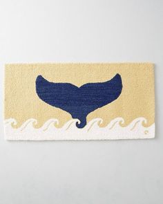 a bath mat with a whale tail on it