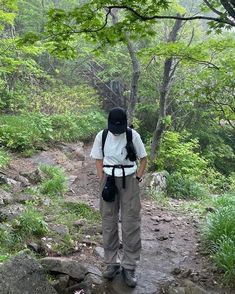 a person with a backpack standing on a trail