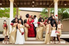 a group of people standing next to each other in front of a gazebo at a wedding