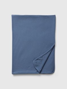 a blue blanket folded on top of a table