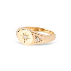 a gold signet ring with diamonds in the middle and a star on it's side