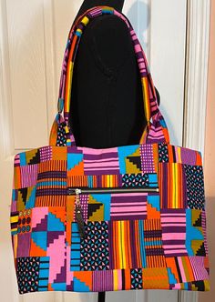 "Abu is a vibrant, Multi-Color Purple ToneTote Bag. It is one of our best selling bags. This is a small/medium size Tote. It's perfect for carrying your essentials. It features: -19\" Shoulder Straps  -Double Slip Interior pockets -Magnetic snap closure -Front Exterior zipper pocket  -Zipper Pull -Key Holder  Dimensions: 16 inches x 12.5 inches height Matching Clutch and Wallet available separately" Multicolor Crossbody Shoulder Bag For On-the-go, Casual Multicolor Bags With Large Capacity, Casual Multicolor Large Capacity Bag, Trendy Zipper Pouch Shoulder Bag, Casual Multicolor Shoulder Bag With Large Capacity, Casual Multicolor Large Capacity Shoulder Bag, Casual Multicolor Large Capacity Satchel, Trendy Satchel Shoulder Bag With Zipper Pouch, Trendy Tote Bag With Zipper Pouch