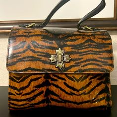 Condition - New With Tag Style - Absolutely Gorgeous Tiger Print Hand Bag. This Bag Has A Twist Lock To Keep Your Goods Nice And Secure. There Are Five Compartments Where Two Of Them Zip. Other: No Shoulder Strap Included And 100% Authentic. Brown Handheld Satchel For On-the-go, Brown Rectangular Flap Bag For Shopping, Brown Top Handle Box Bag With Handle Drop, Brown Box Bag With Handle Drop Top Handle, Brown Box Bag With Handle Drop And Top Handle, Vintage Brown Flap Bag With Top Handle, Black Flap Bag With Handles, Brown Satchel Box Bag With Handles, Brown Satchel Box Bag