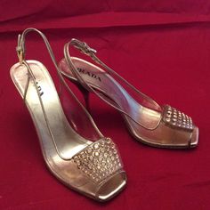 "clear plastic vinyl with gold leather trim by Prada made in Italy Gently worn, loss of gold color on trim and heel edge, metal spike heel with amber resin heel accent. All rhinestones are there, no damage , only marks and signs of normal wear. 9 7/8\" insole 3\" heel 3 \"sole width Leather sole" Gold Heels With Metallic Accents For Party, Gold Patent Leather Heels, Gold Heels With Rhinestones, Open Heel Style, Gold Patent Leather Heels With Almond Toe, Luxury Heels With Metallic Accents For Formal Occasions, Gold Closed Toe Heels With Metal Feet, Chic Gold Heels With Metal Feet, Gold Almond Toe Patent Leather Heels, Chic Embellished Gold Heels