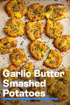 garlic butter smashed potatoes on a baking sheet with text overlay that reads garlic butter smashed potatoes