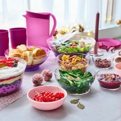 a table topped with lots of different types of food and desserts next to each other