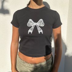 "black baby tee with white lace bow 100% cotton Model is wearing size S and is a 6/8 - For reference, model is 5'5 with 31\" bust and 26\" waist" Diy Baby Tee, Black Tee Outfit, Bow Clothes, Baby Tee Outfit, Lace Butterfly, Womens Graphic Tees, Black Graphic Tee, Slim Fit Crop Top, Coquette Style