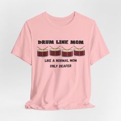 Celebrate the special moms who support their drummers with our exclusive "Drumline Mom - Like a Normal Mom But Deafer" t-shirt. This fun and witty shirt is perfect for any proud drumline mom who stands by her child at every rehearsal and performance, despite the noise! Made from high-quality Bella Canvas fabric, this unisex tee offers comfort and style for everyday wear. This classic unisex jersey short sleeve tee fits like a well-loved favorite. Soft cotton and quality print make users fall in Drumline Shirts, Marching Band Gift, Band Mom Shirts, Band Mom, Funny Music, Music Teacher Gifts, Mama T Shirt, Music Humor, Drummers