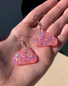 "Each pair of resin earrings are made to order, therefore no two pairs are identical! However, I try to get as close as possible :) Made with nickel free, hypoallergenic fish hooks.  Each cloud is approximately 1.25\" wide and has pink holographic chunky mix glitter ✨ Thanks for visiting my shop! ☁️" Whimsical Nickel-free Resin Earrings, Cute Resin Drop Earrings, Whimsical Pink Resin Earrings, Handmade Clear Resin Earrings, Unique Pink Resin Earrings, Edc Outfits, Pink Sparkly, Pink Clouds, Trendy Earrings