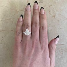 a woman's hand with a diamond ring on it