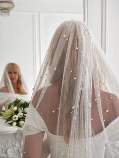 the back of a bride's veil with pearls