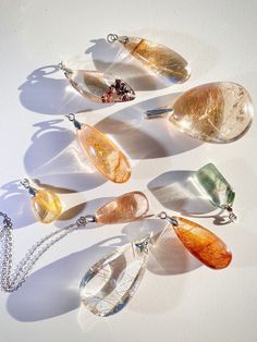 You will receive an intuitively chosen pendant - please choose your preferred chain options, and whether you would like a pendant of garden quartz or rutile quartz. Photos in this listing are indicative of the quality of the pendant which will becomes yours. ❤️ Selectively curated, high quality inclusion quartz pendants, set in a 0.925 sterling silver bail, and with an optional sterling silver chain necklace. Each pendant is individually sourced and chosen for gleaming, striking rutile formations, and aesthetic, scenic garden inclusions. Only the highest quality, most picturesque and clear quartz pieces are sourced.  Each one is a special treasure. A. Garden quartz pendant B. Garden pendant with chain C. Rutile quartz pendant D. Rutile quartz pendant with chain All jewelry purchases over $ Spiritual Silver Necklace With Natural Inclusions, Spiritual Gemstone Teardrop Pendant Crystal Necklaces, Spiritual Teardrop Gemstone Crystal Necklace, Sterling Silver Teardrop Pendant Crystal Necklace, Sterling Silver Teardrop Pendant Crystal Necklace Gift, Sterling Silver Teardrop Crystal Necklace As Gift, Spiritual Silver Teardrop Crystal Necklace, Amber Drop Gemstone Necklace, Spiritual Teardrop Necklaces With Large Pendant