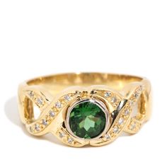 Beautifully crafted in 18 carat gold, The Alexis Ring is a stunning jewel.  Her vivid green tourmaline is set in a scrolling weave of diamond embellished gold.  Make her your family story for generations to come.   The Alexis Ring Gem Details The centre round deep green tourmaline is estimated to weigh 0.96 carats. The twenty one round brilliant cut diamonds are estimated to weigh 0.10 carats, are G to H colour and SI to P1 clarity grades.  Ring Size  Q (Australia and UK sizing) or 8 1/2 (US and Formal Yellow Gold Tsavorite Rings, Formal Yellow Gold Emerald Ring, Elegant Tsavorite Birthstone Ring, Gold Tourmaline Ring For May Birthstone, Elegant Yellow Gold Tourmaline Emerald Ring, Formal Tourmaline Rings For May Birthstone, Formal Fine Jewelry Tourmaline Birthstone Ring, Tourmaline Birthstone Ring, Fine Jewelry For Formal Events, Elegant Yellow Gold Tourmaline Birthstone Ring