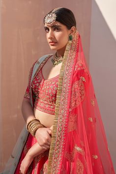 Red lehenga embroidered with traditional zardozi technique using silken threads, dabka, cutdana and sequins in a teardrop pattern. Comes with embroidered half sleeve blouse, one sheer dupatta and one fringe border dupatta.
Component: 4
Pattern: Embroidery
Type Of Work: Zardozi, Silken Threads, Dabka, Cutdana and Sequins
Neckline: Leaf
Sleeve Type: Half
Fabric: Raw Silk
Color: Red
Other Details: 
Blue sheer dupatta with embroidered border
Red dupatta with fringe border
Low back with tie up and ta Diwali Embroidered Lehenga For Traditional Ceremonies, Embroidered Lehenga For Traditional Ceremonies At Diwali, Embroidered Lehenga For Diwali And Traditional Ceremonies, Dola Silk Lehenga With Zari Work For Traditional Ceremonies, Resham Embroidery Lehenga For Traditional Ceremonies, Cutdana Choli For Traditional Ceremonies, Embroidered Lehenga For Traditional Ceremonies And Navratri, Kundan Choli With Pallu For Traditional Ceremonies, Semi-stitched Lehenga With Resham Embroidery For Traditional Ceremonies