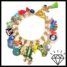 "LOADED gold charm bracelet just the way you like it with the addition of Crystals!! Tons of enamel charms with Czech crystals in between! Stunning! 7 3/4\" length with Lobster Clasp and adjustment chain. Actual charms may vary. All of my jewelry is handmade by me. No two are exactly alike. Hence the name, \"OKO by Andy\" (One-of-a-Kind). The photos in the listings are indicative of the style you will receive, not necessarily an exact representation since these are not mass made in a factory." Gold Charm Bracelet As A Souvenir, Gold Enamel Bracelets With Charms, Gold Enamel Bracelet With Charms, Enamel Charms Bracelet, Gold Charm Bracelet, Czech Crystal, Enamel Charms, Gold Charm, Just The Way