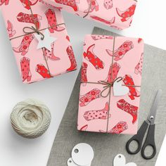 wrapping presents with scissors and twine on the table