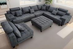 a large sectional couch and footstool in a living room